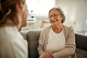 An elderly woman speaking with her medicare provider about her healthcare needs.