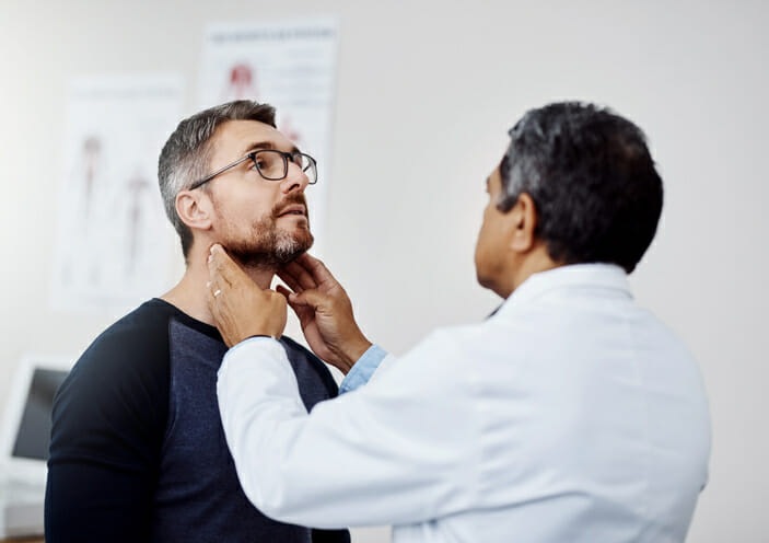 mature male doctor doing a checkup
