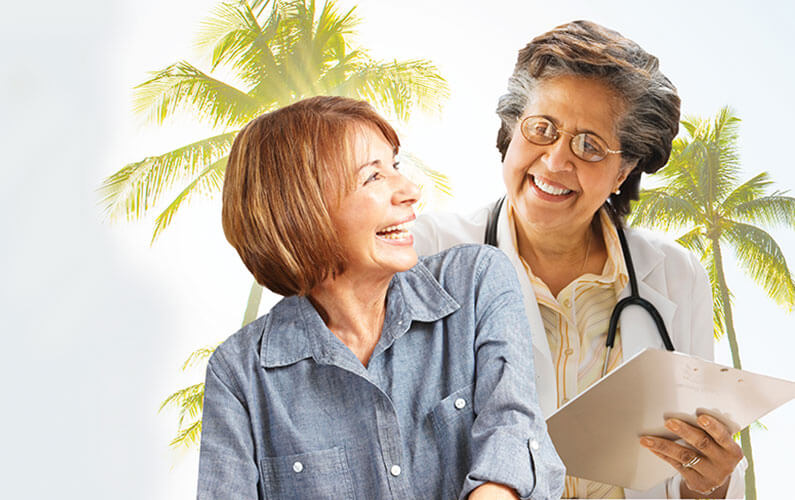A primary care doctor that takes Aetna insurance coverage smiling with her patient.