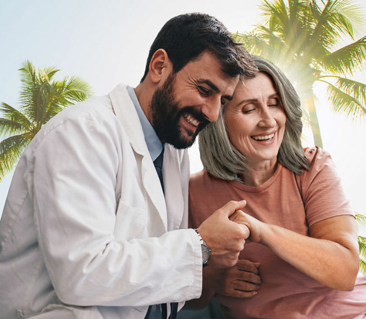Senior primary care doctor smiling with his South Florida patient.