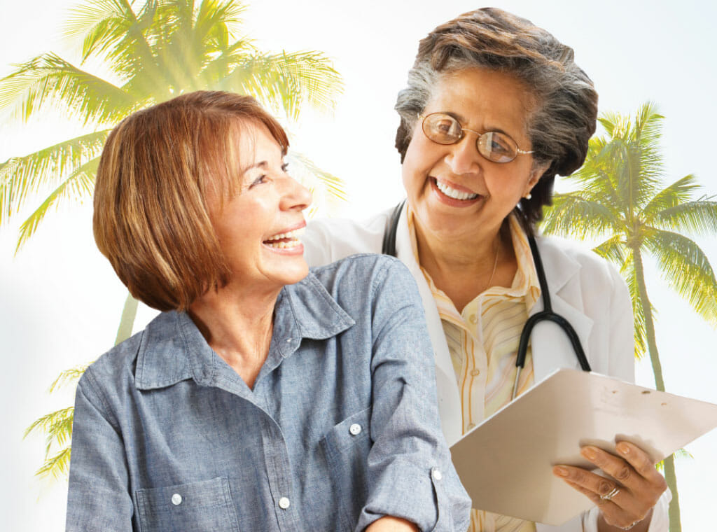 Senior primary care doctor smiling with her patient.