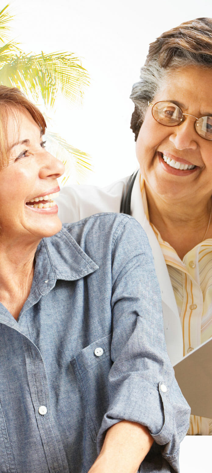 Senior primary care doctor smiling with her patient.