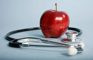 red apple and stethoscope- preventive medicine concept