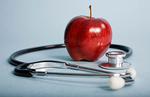 red apple and stethoscope- preventive medicine concept