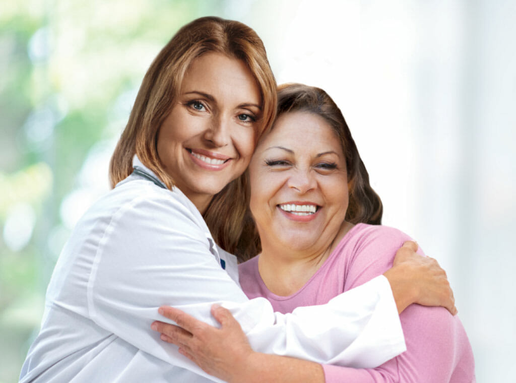 An Aetna affiliated doctor smiling with her patient.