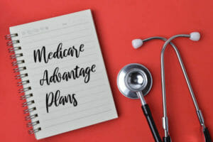 Stethoscope and notebook written with text MEDICARE ADVANTAGE PLANS.