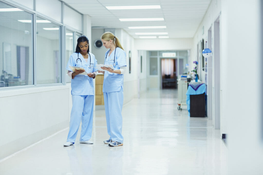 Nurses discussing medical documents in medical center