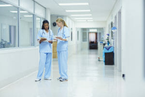 Nurses discussing medical documents in medical center