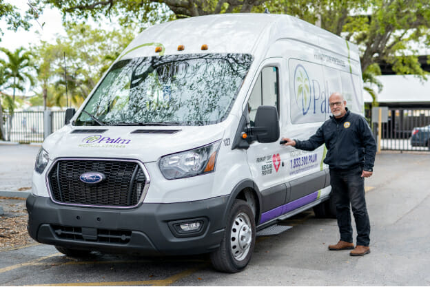Palm Medical Centers non-emergency medical transportation vehicle and driver.