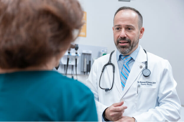 Palm Medical Centers doctor talking to a patient.