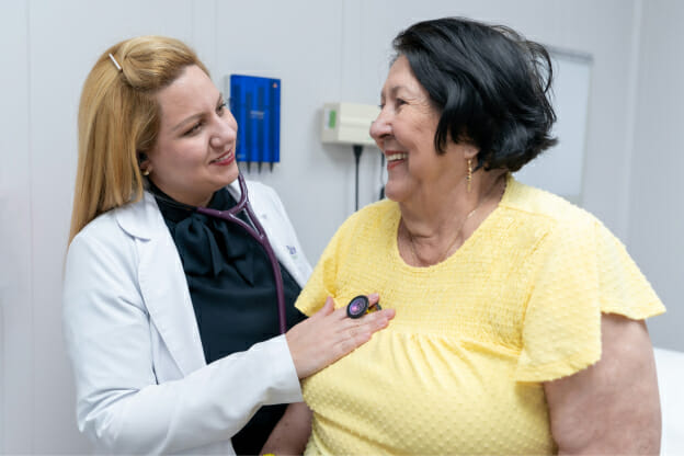 Palm Medical Centers doctor checking a patient's heartbeat.