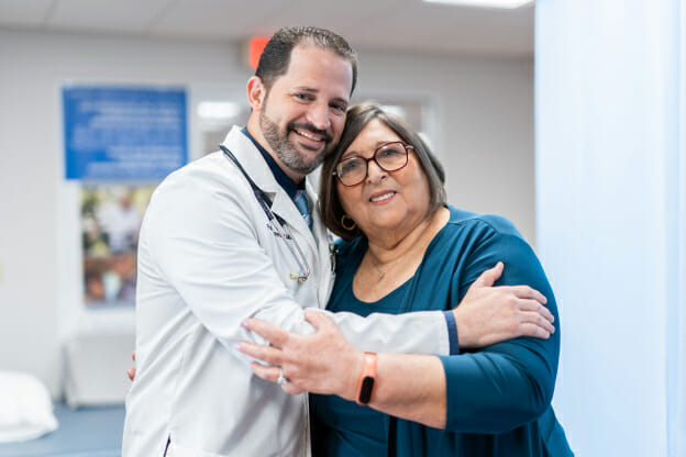 Palm Medical Centers primary care doctor hugging a patient.