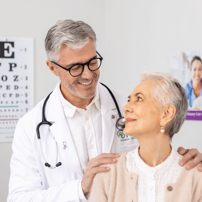A male doctor looking happily at his female patient.