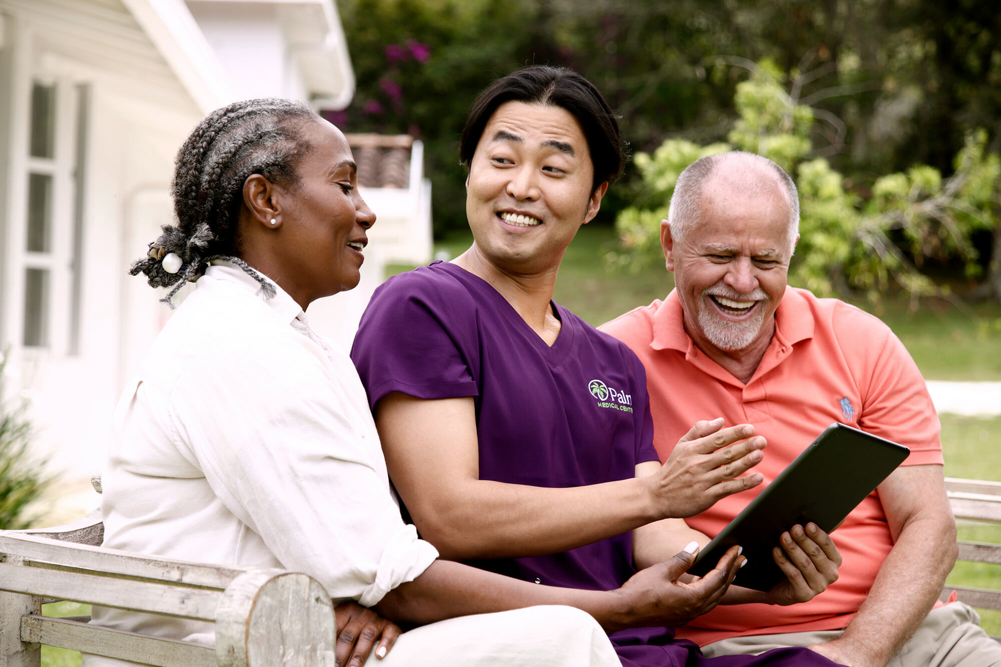 A Palm Medical Centers healthcare provider sitting and laughing with his patients.