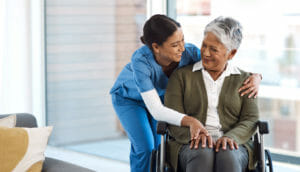 young female nurse with a senior wheelchair-bound patient