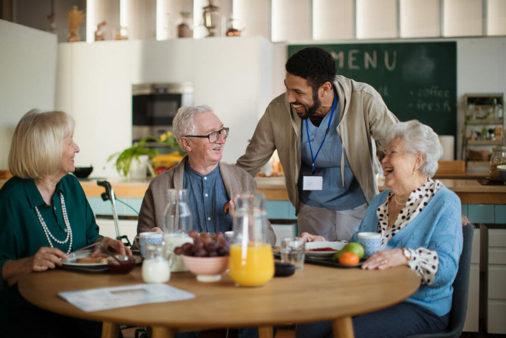 Group of cheerful seniors enjoying breakfast