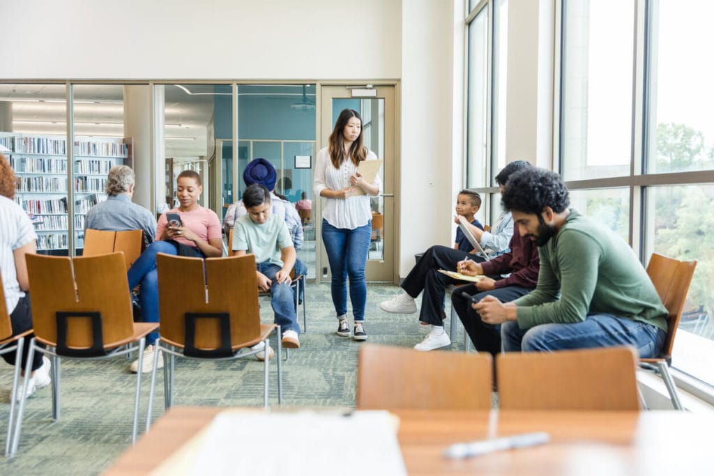 Diverse people wait at medical center