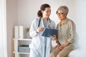 A senior female Patient with a geriatric doctor in a medical office.